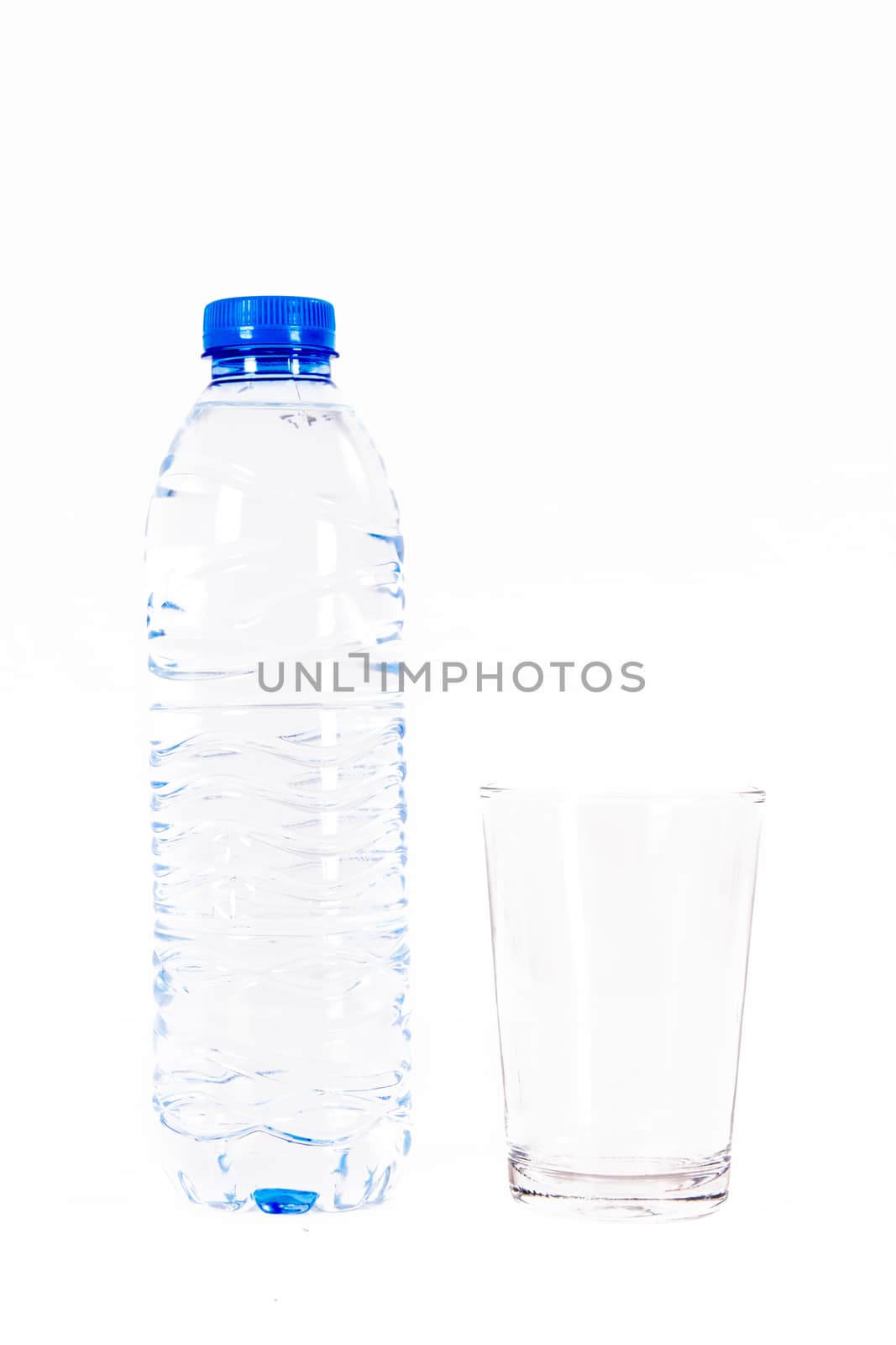 Plastic water bottle and glass, isolated on white background.