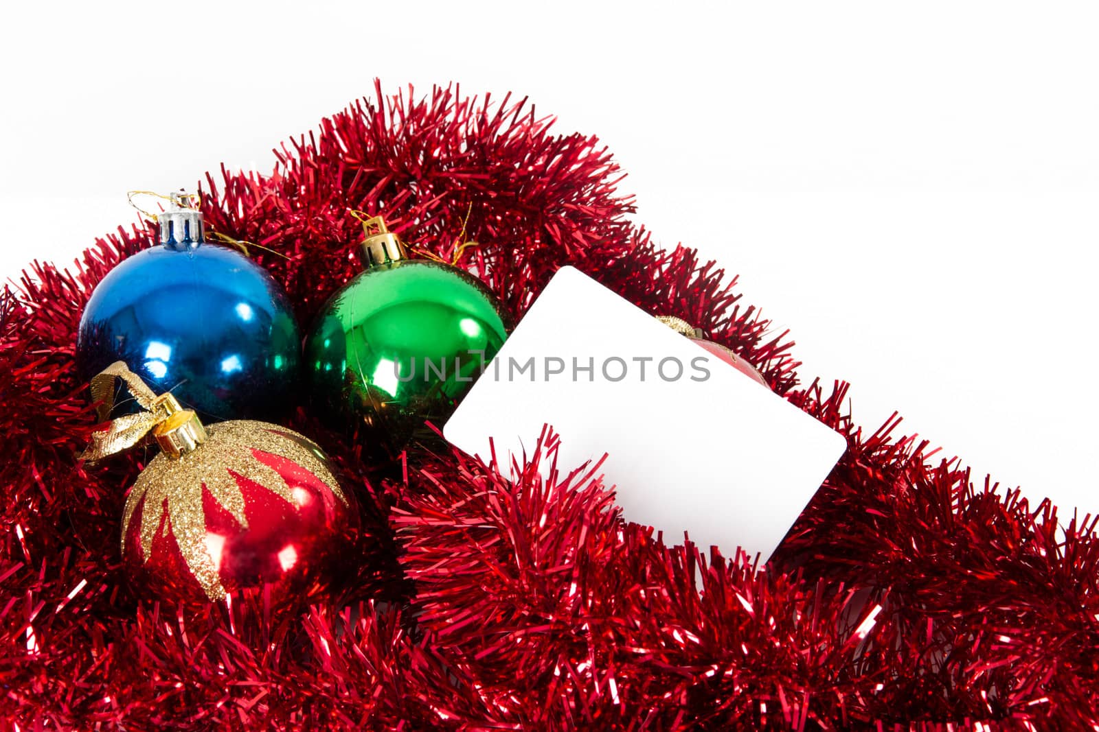 Christmas ornaments and blank greeting card for your message, isolated on white background.