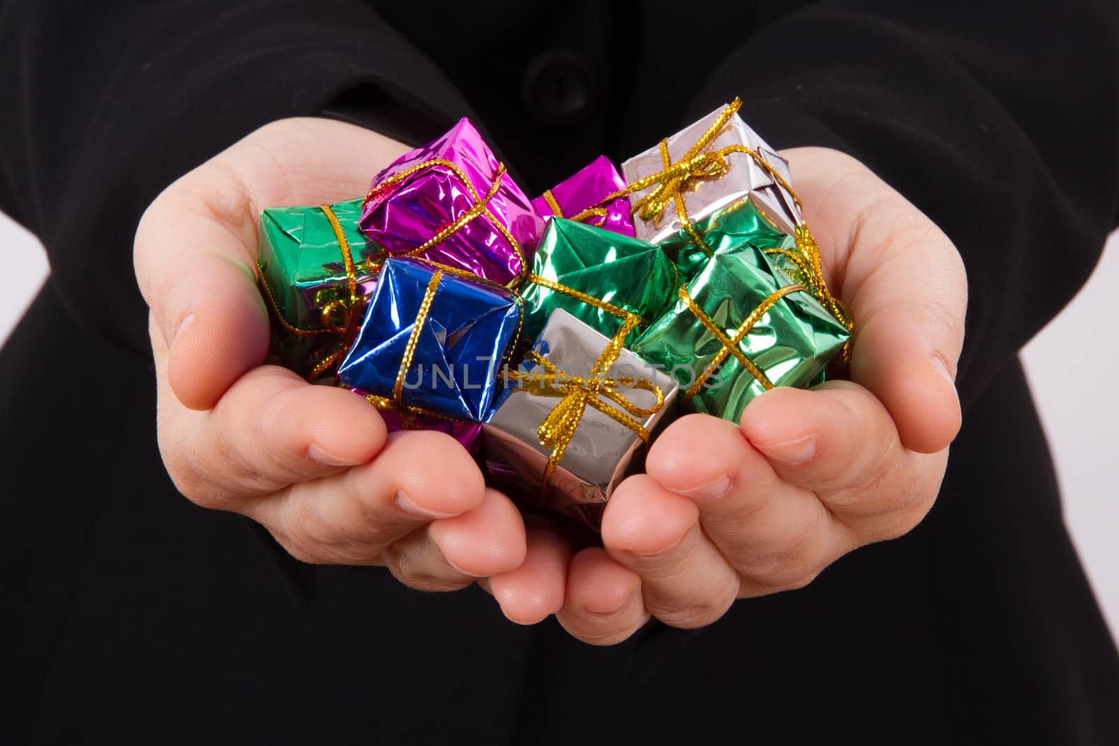 Hands extend colorful gift boxes.