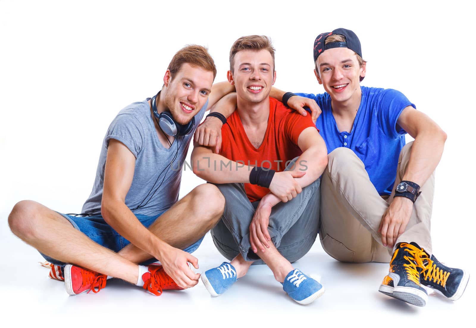 Portrait of three young happy smiling teenagers. Isolated on white background.