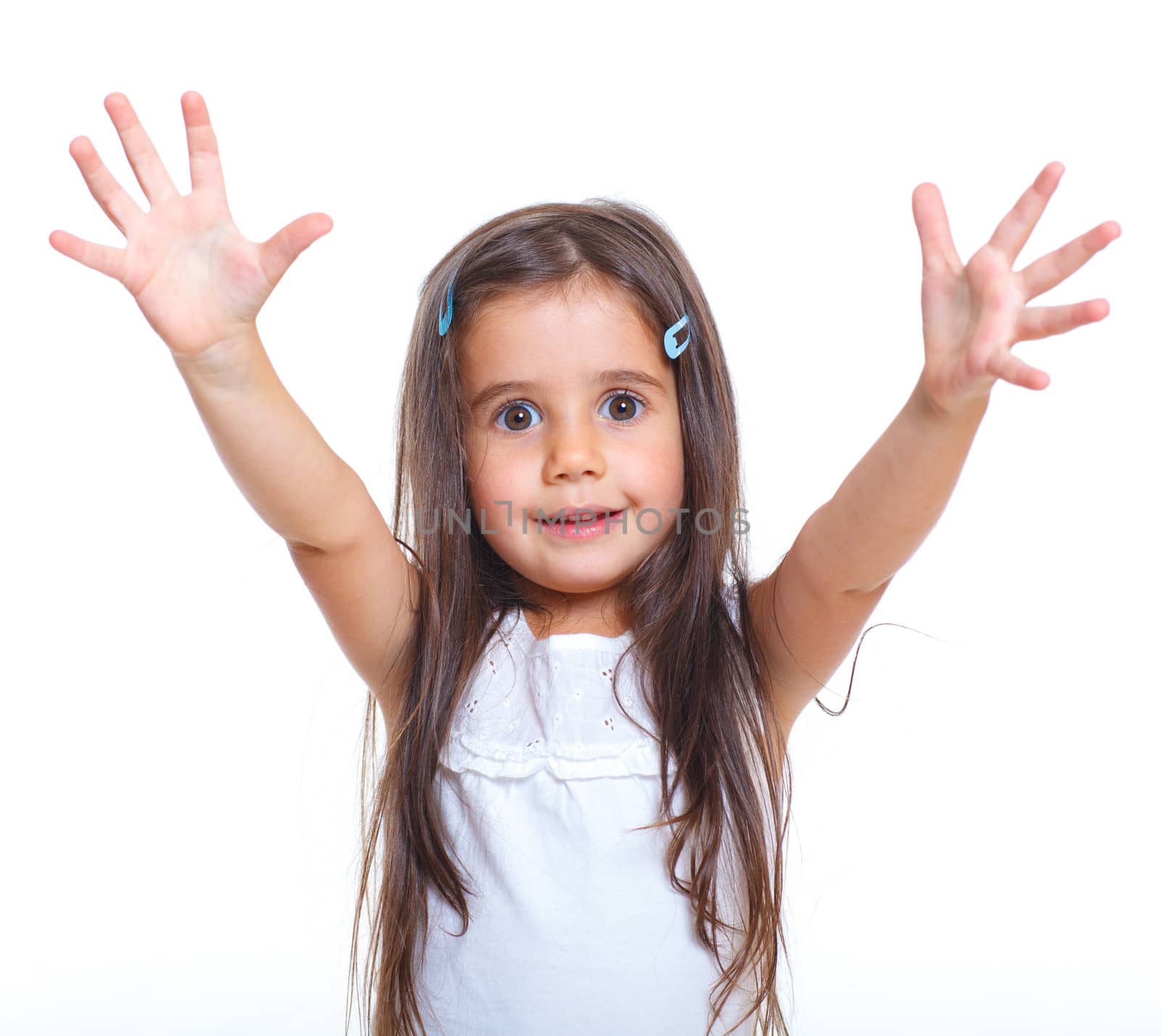 Beautiful little girl with hands up happy smiling in studio. Isolated white background