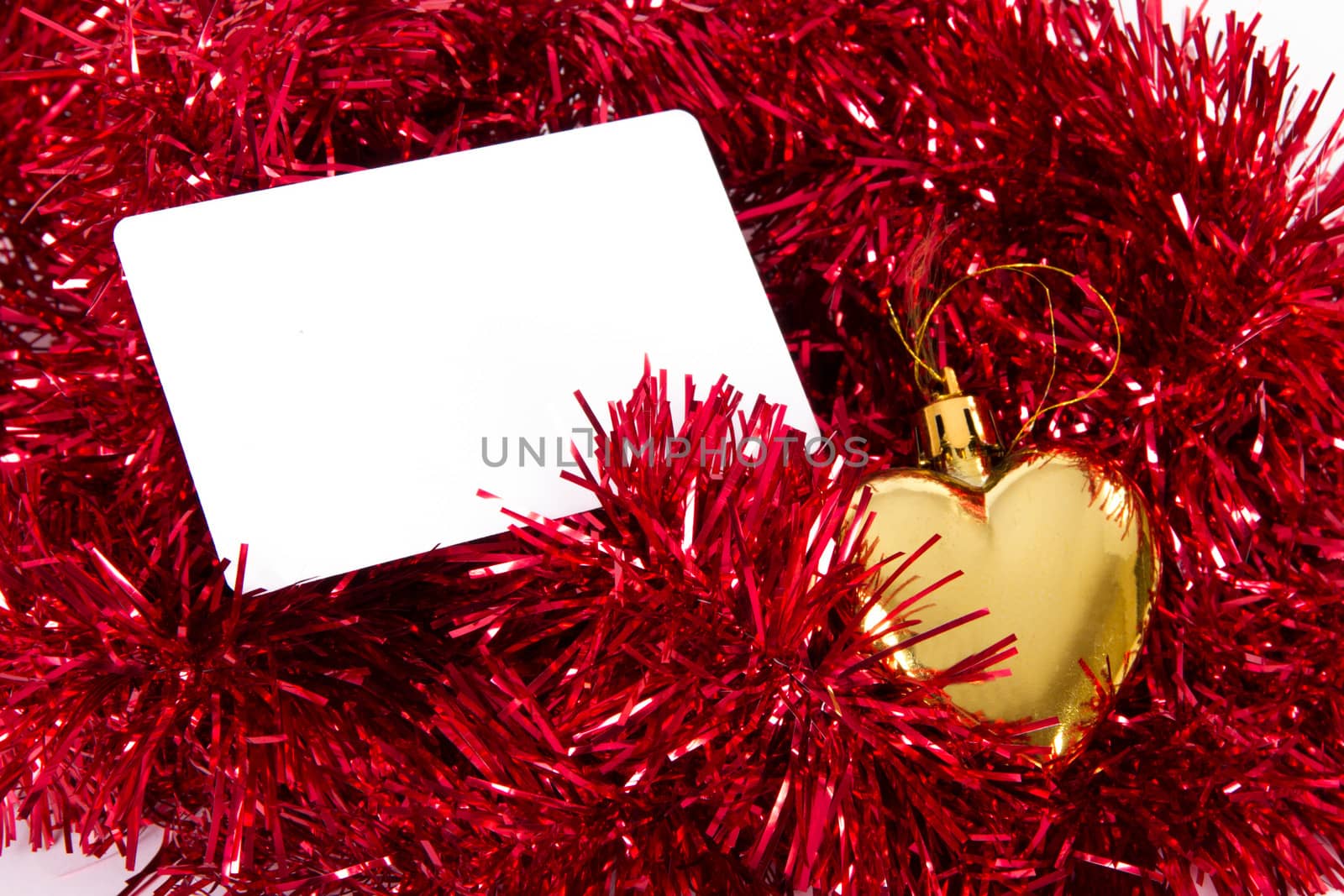 Blank greeting card fpr your message and christmas ornaments with yellow heart.