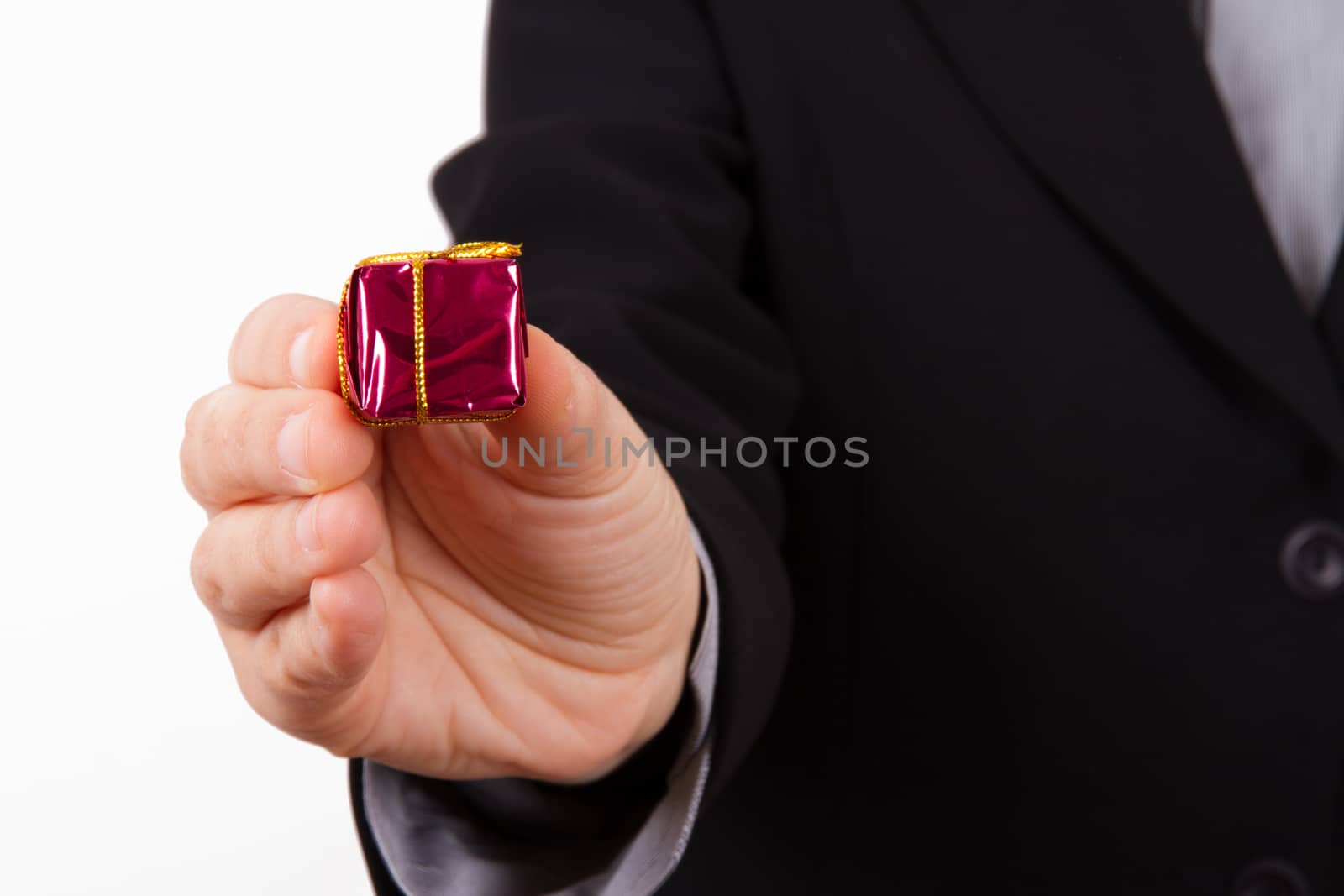 Business woman extends red gift box with yellow rope, isolated on white background.