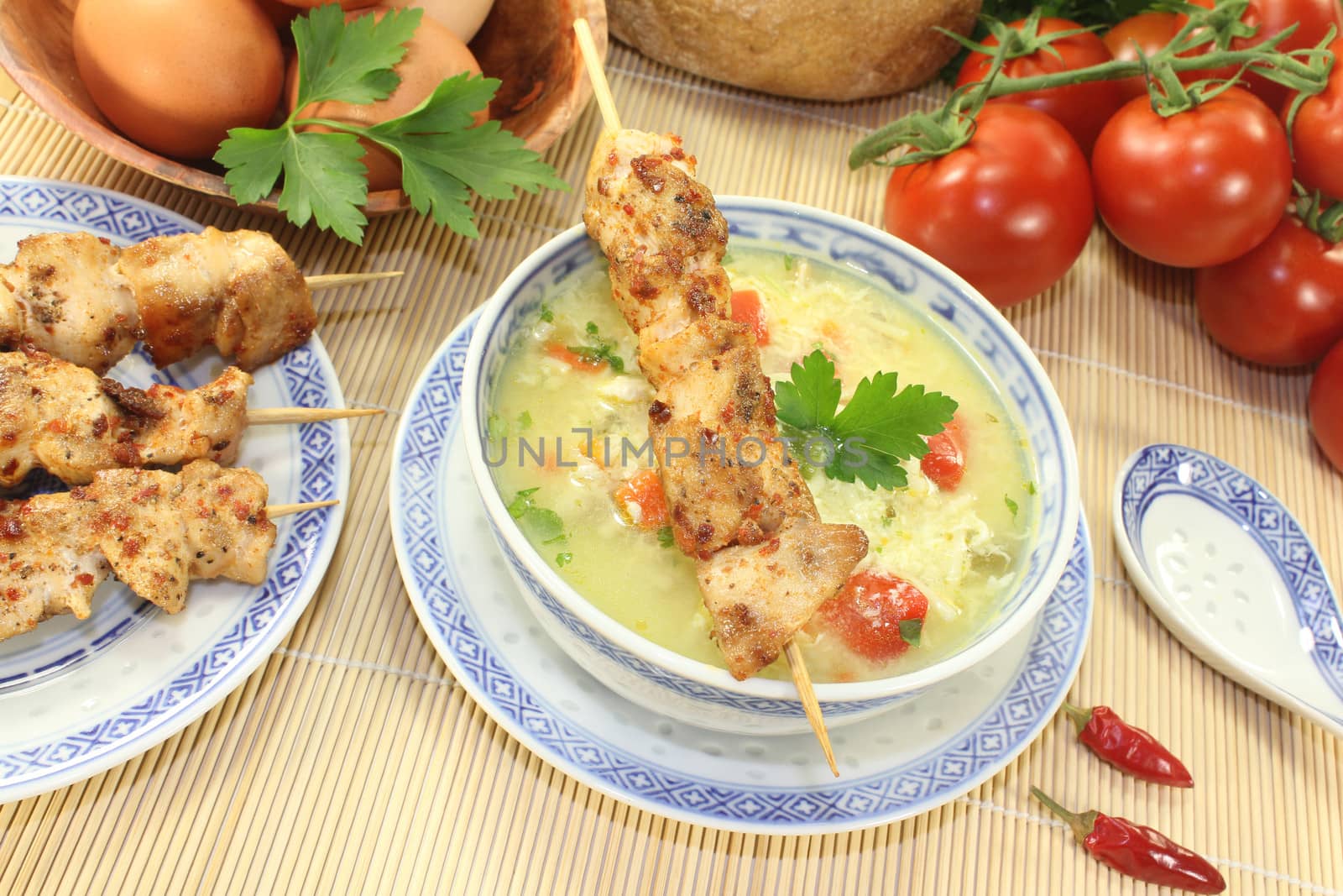 Asian Chicken soup with eggs, noodles and tomatoes