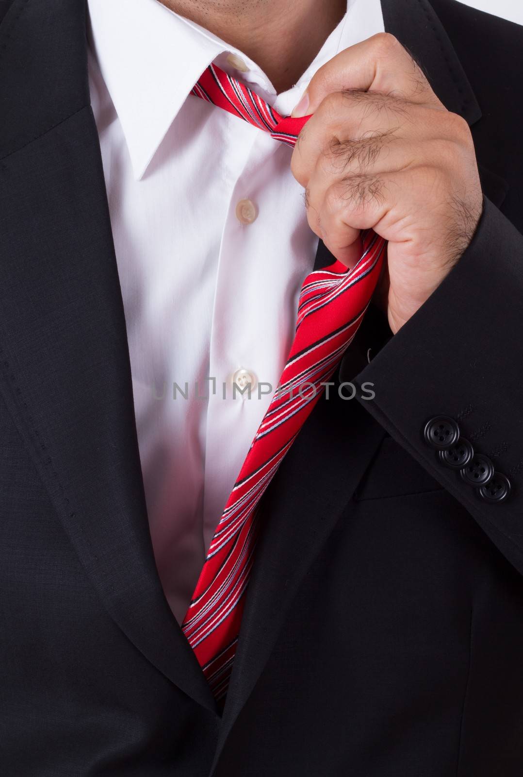 Bored businessman holding red tie.