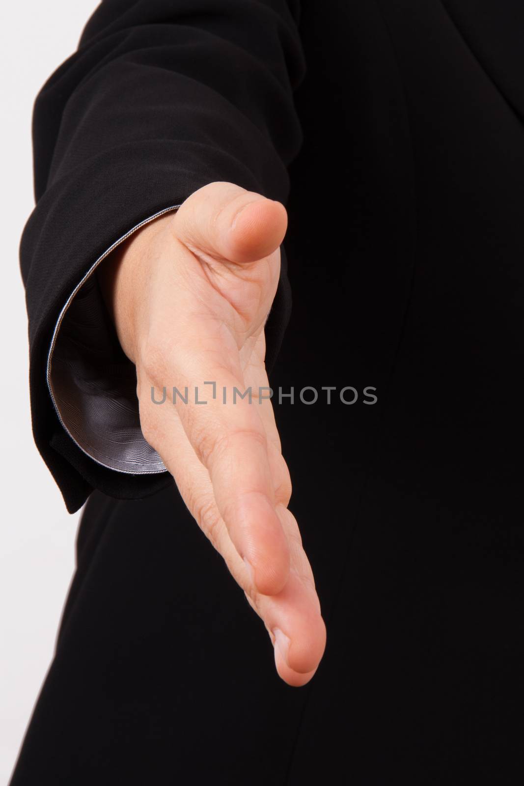Business woman in suit extending hand to shake, isolated on white.