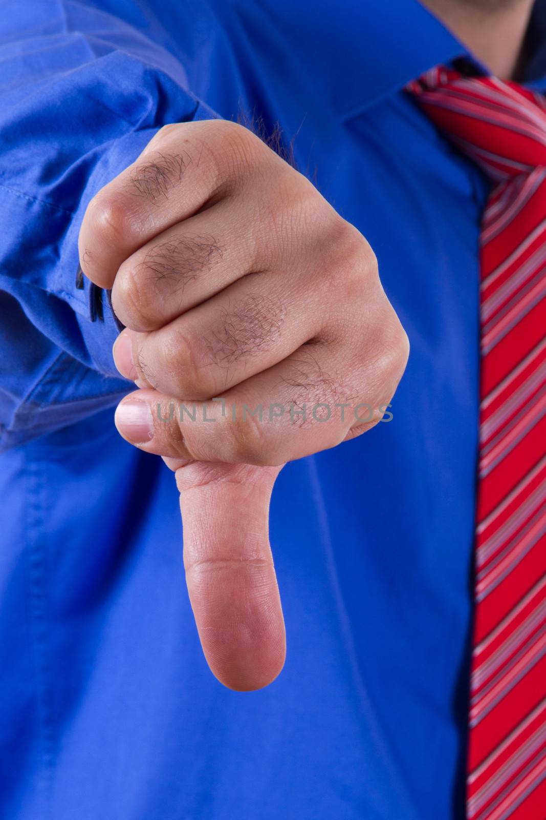 Businessman with blue shirt gesturing not approval, no sign with his hand.
