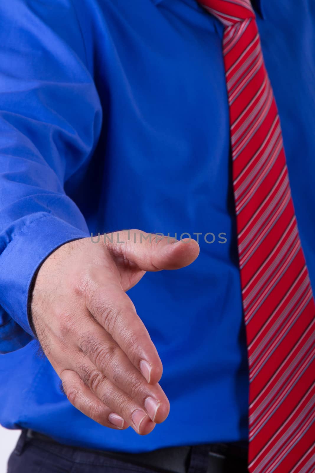 Businessman with blue shirt showing hand for handshake or help.