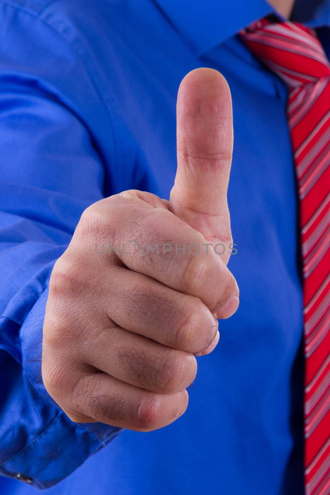 Businessman with blue shirt gesturing approval, yes, ok sign with his hand.