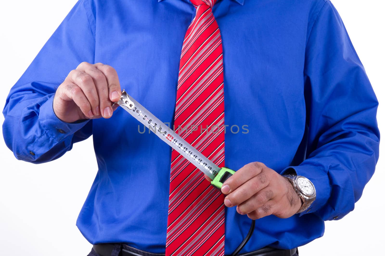 Businessman with red tie and blue shirt holding tape measure, isolated on white background.