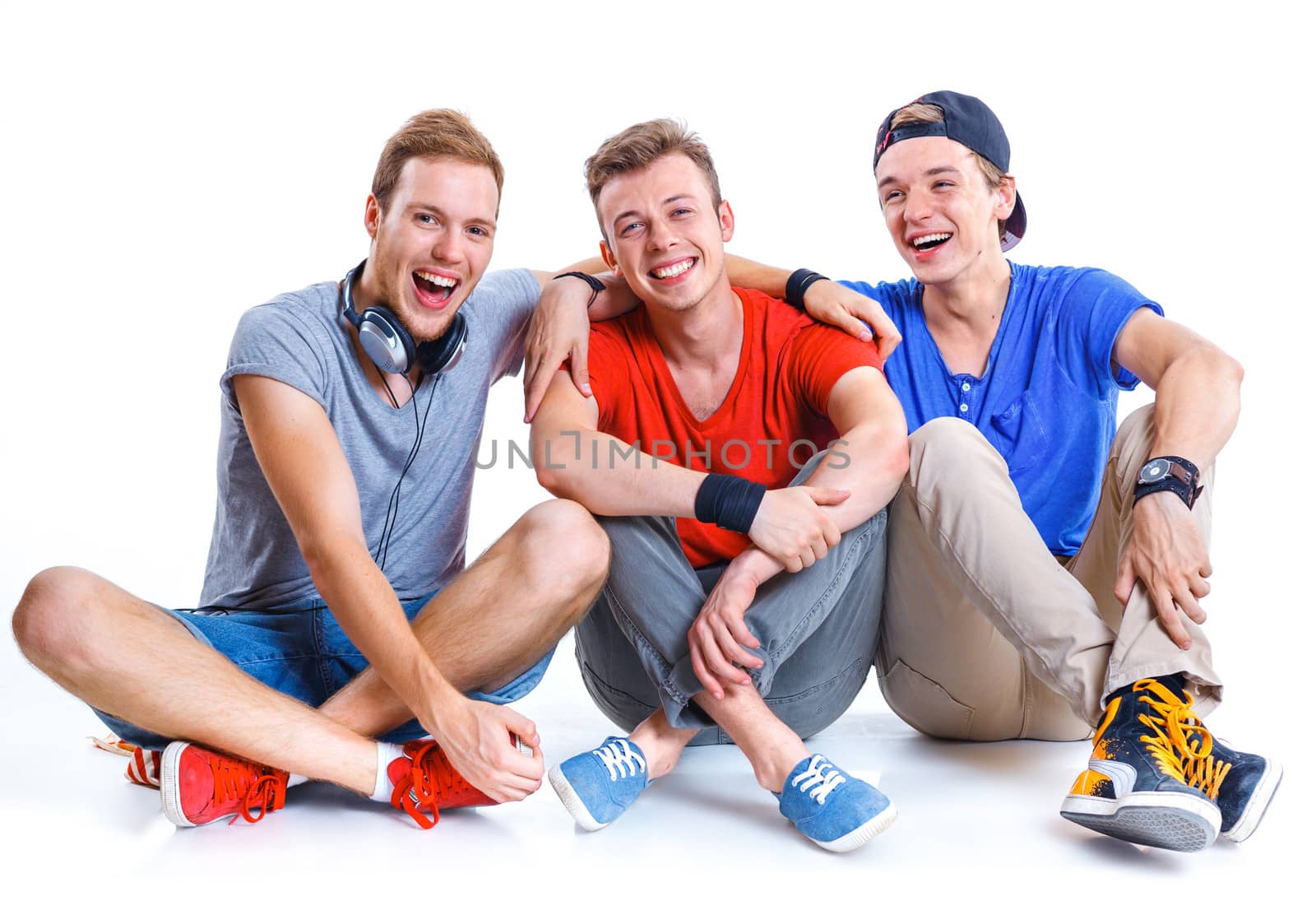 Portrait of three young happy smiling teenagers. Isolated on white background.