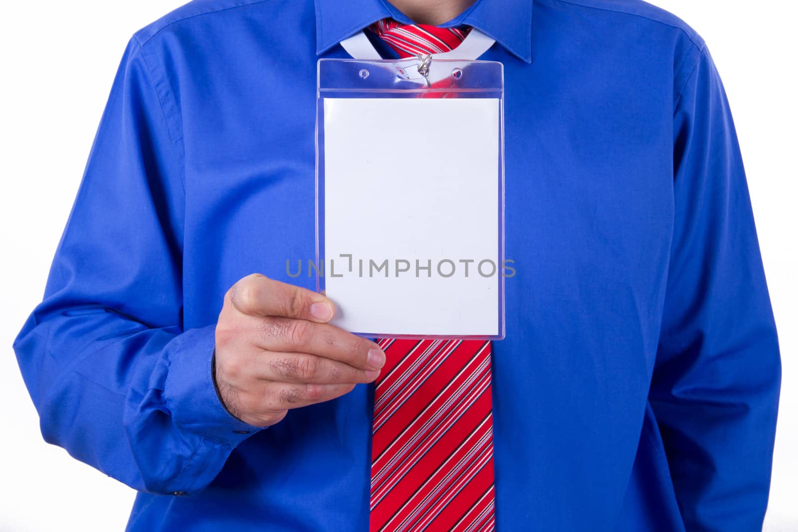 Businessman with red tie and blue shirt holding and showing blank, empty, white identification card, isolated on white background.