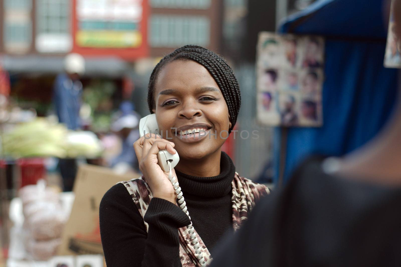 African or black American woman calling on landline telephone in Alexandra township