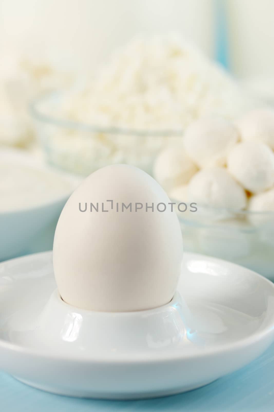 Egg with milk products, still life in white