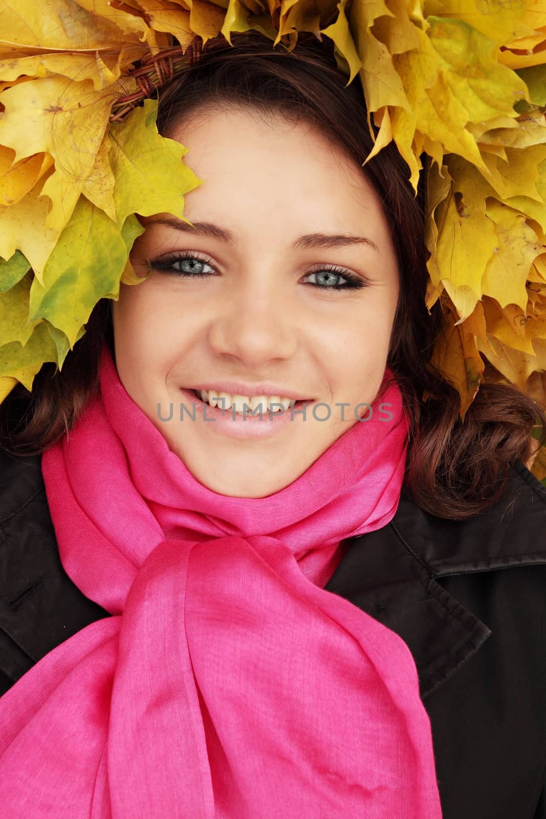 happy woman wearing a wreath of yellow leaves