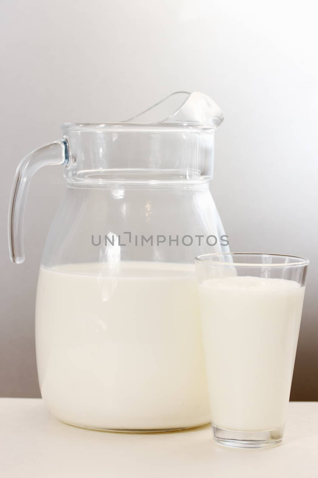 transparent decanter and glass filled with milk