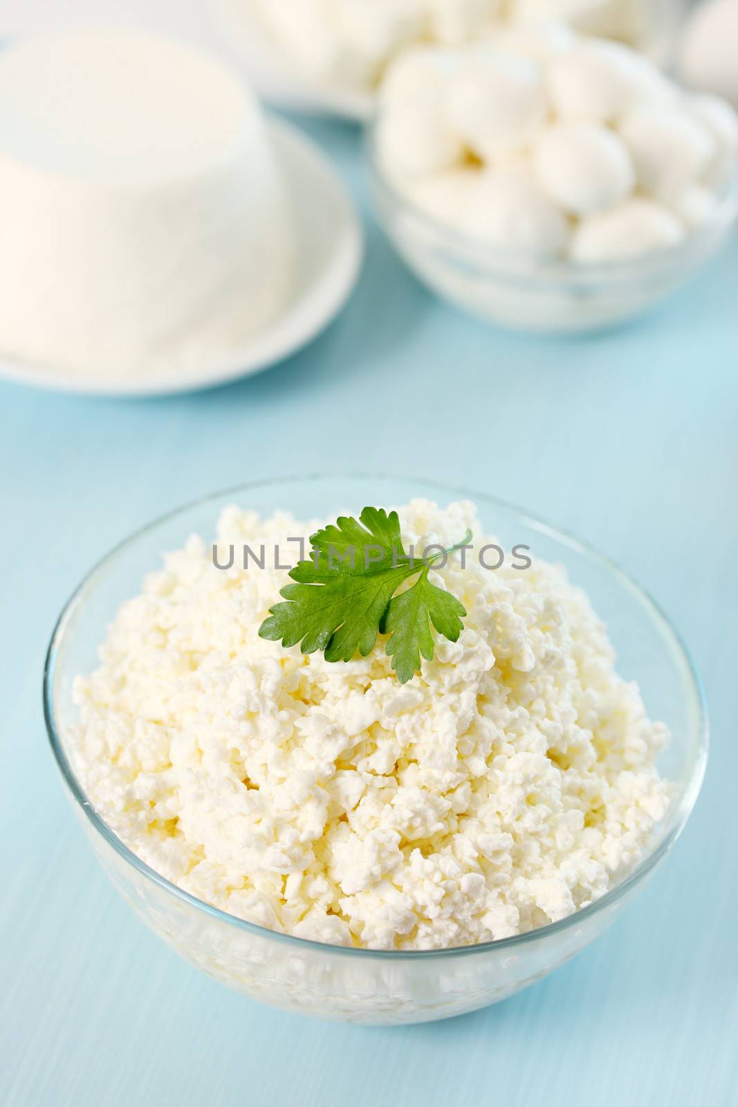 Cottage cheese in a transparent  bowl with parsley