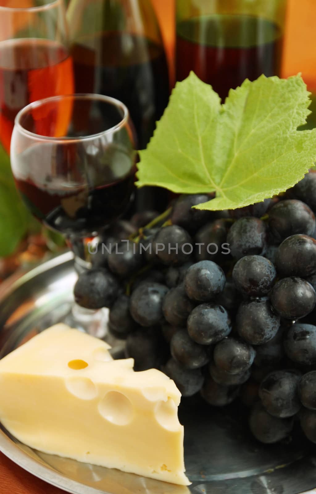 still life with wine bottle, wine glass and grapes