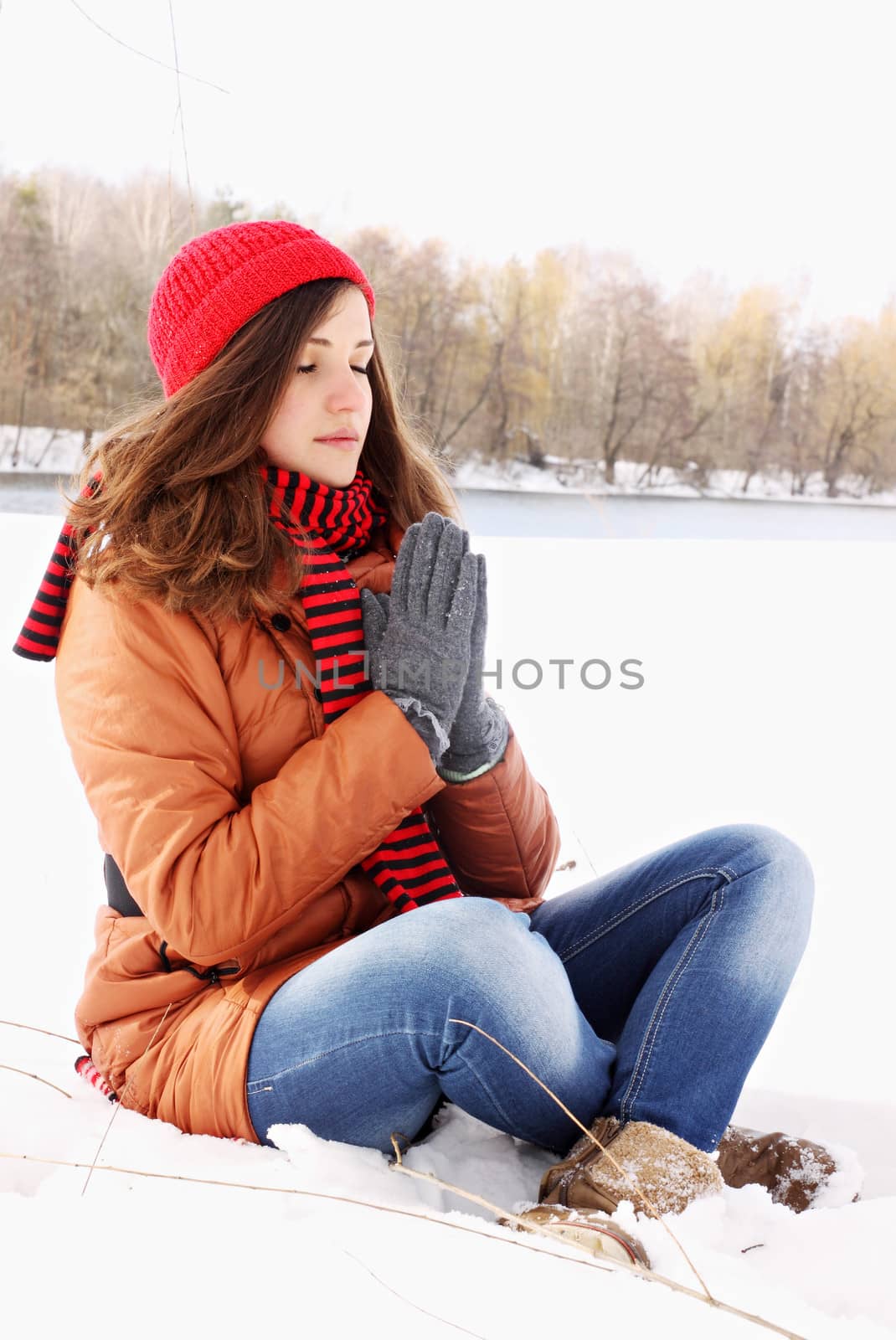 Young girl in lotus pose in the snow