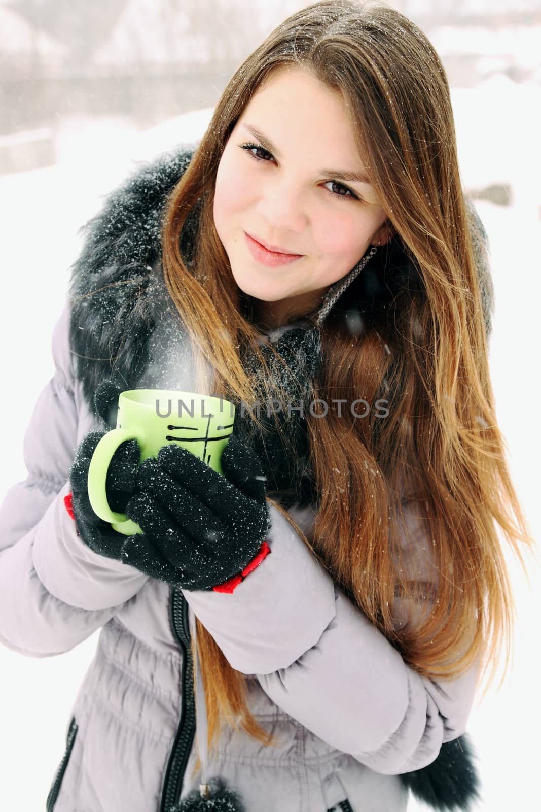 young woman holding a cup with hot drink