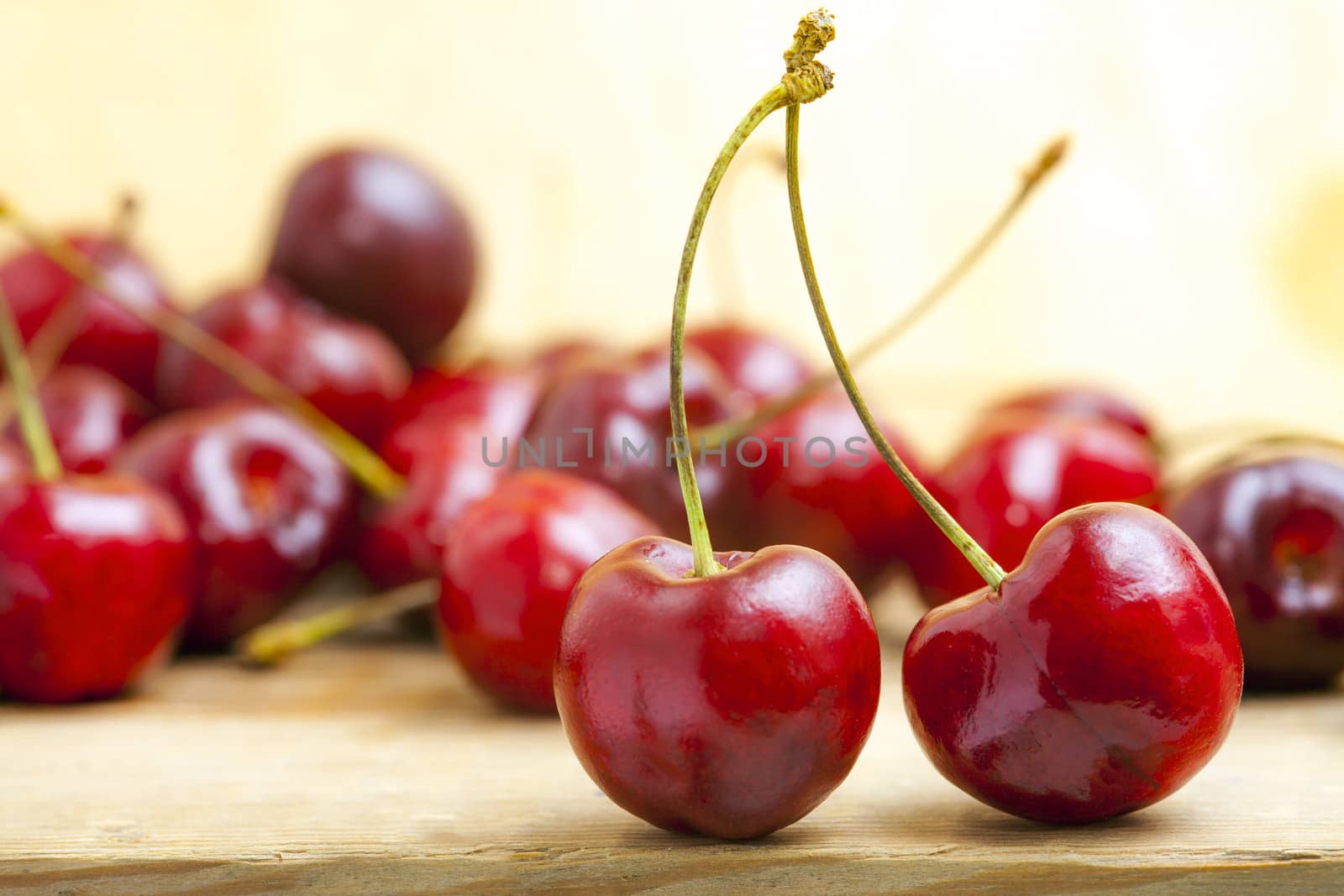 fresh red cherries on a wooden table