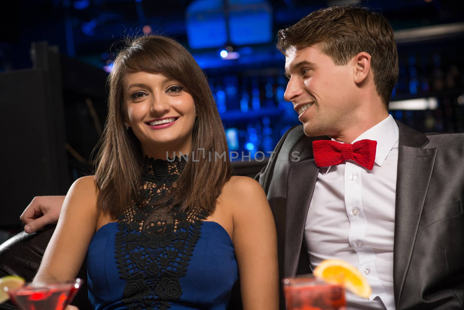 Young couple talking in a nightclub, have fun