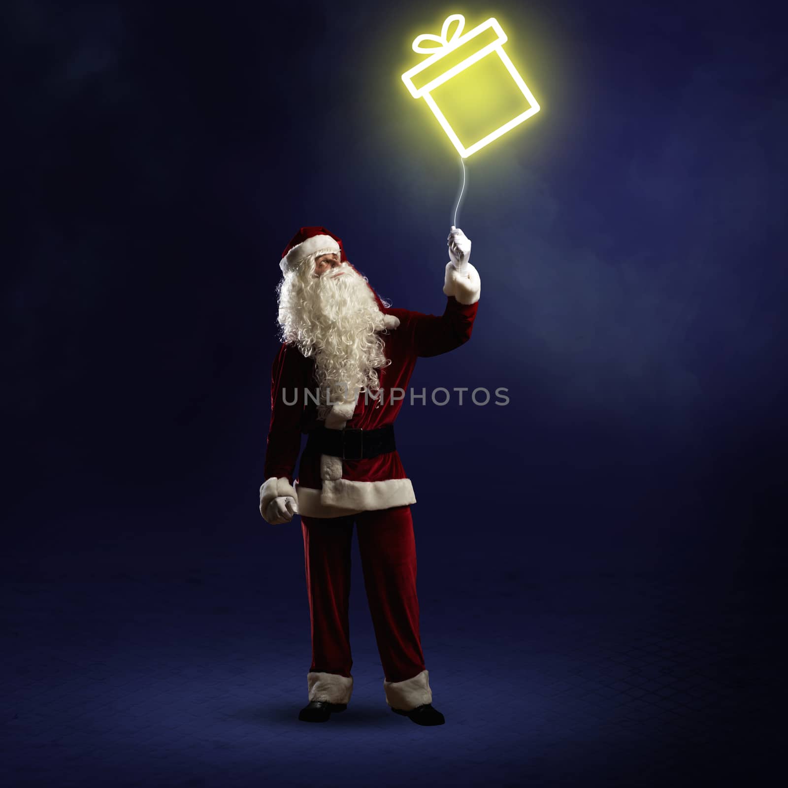 Santa Claus is holding a shining gift by adam121