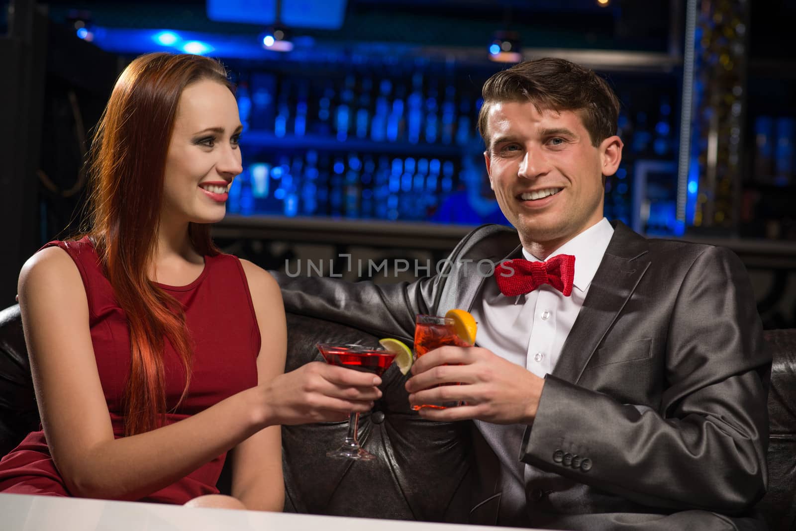 Young couple talking in a nightclub, have fun