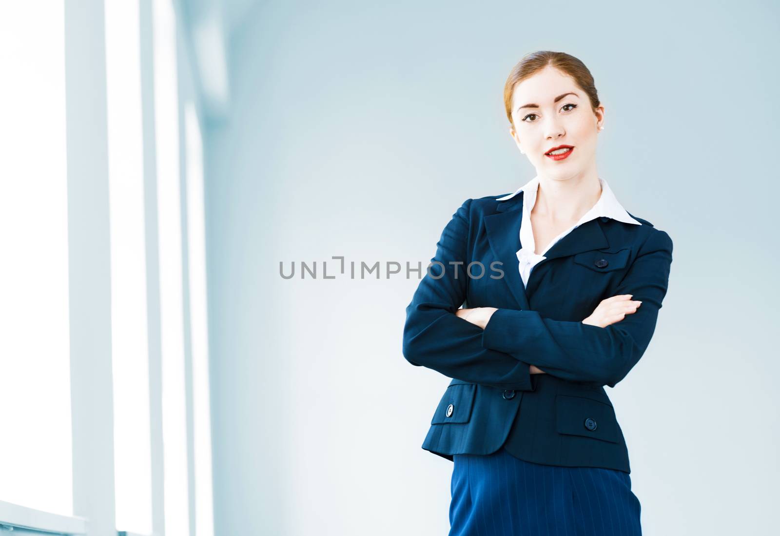 young modern business woman, crossed her arms and smiles