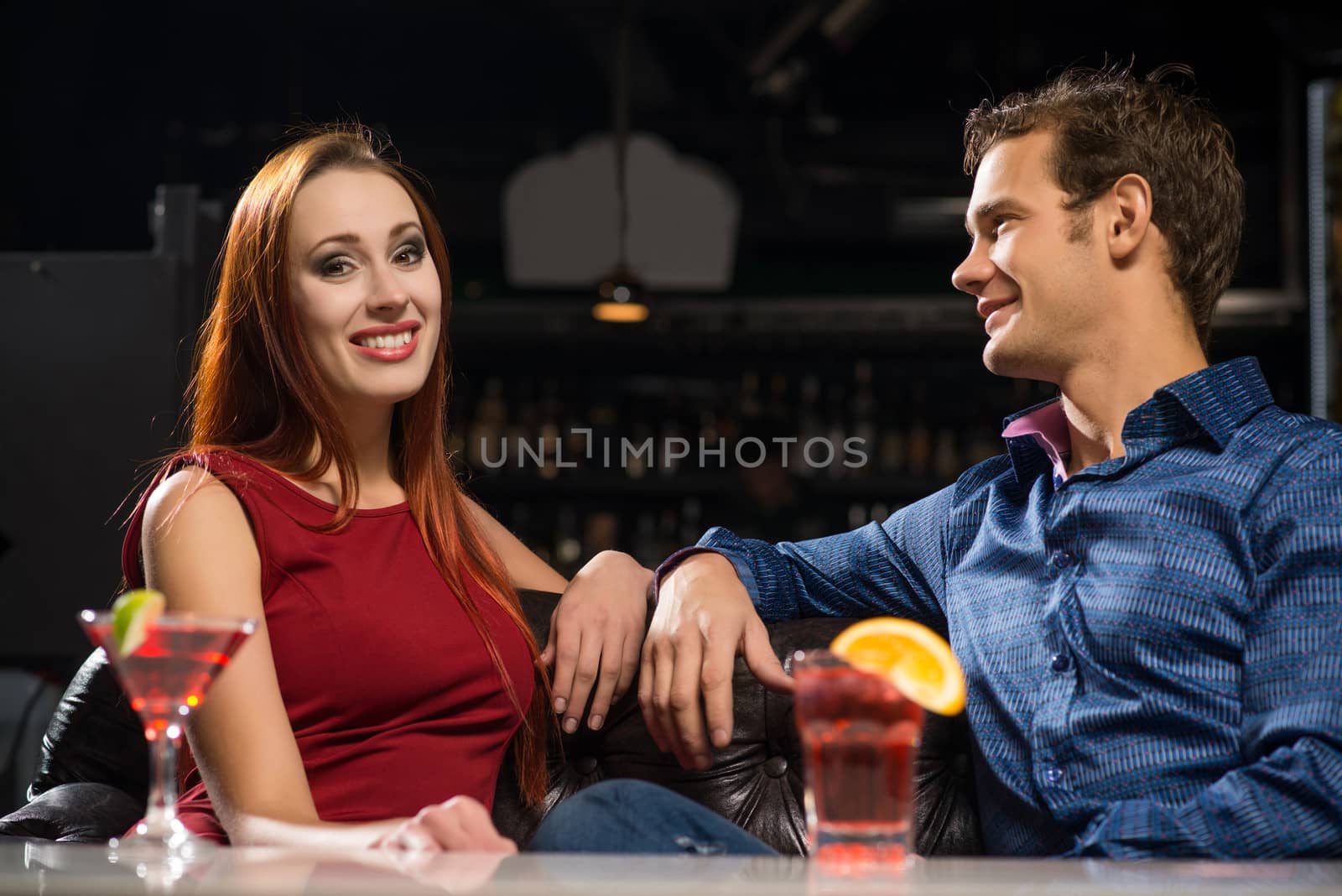 Young couple talking in a nightclub, have fun