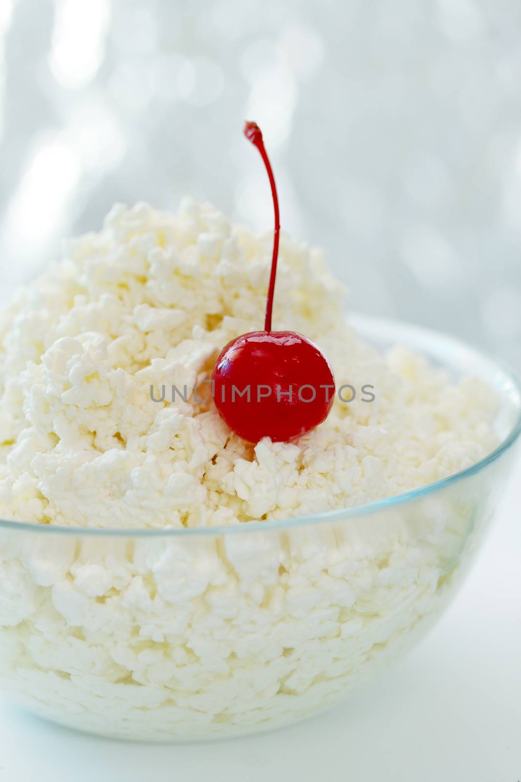 Cottage cheese in a transparent  bowl with cherry