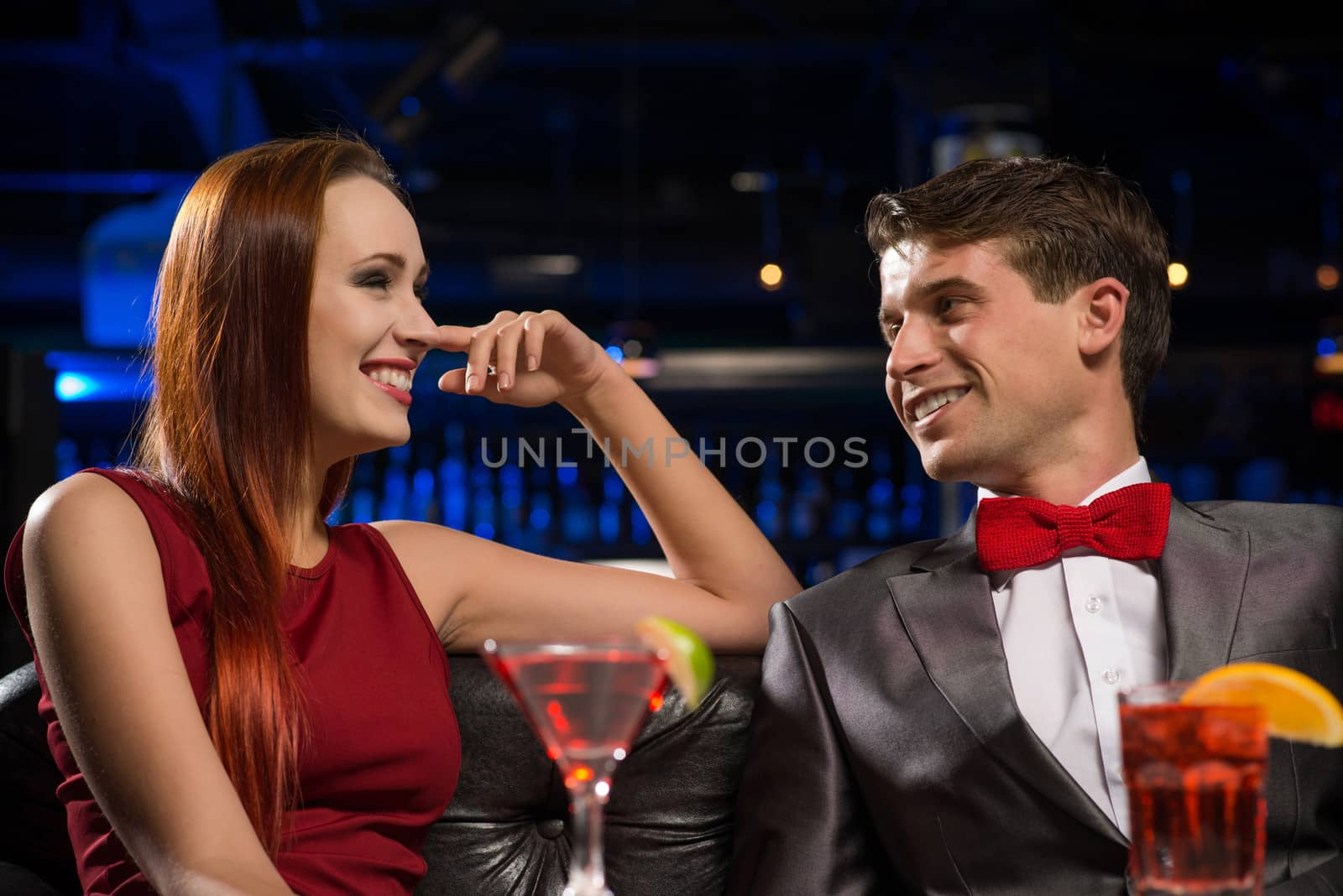 Young couple talking in a nightclub, have fun