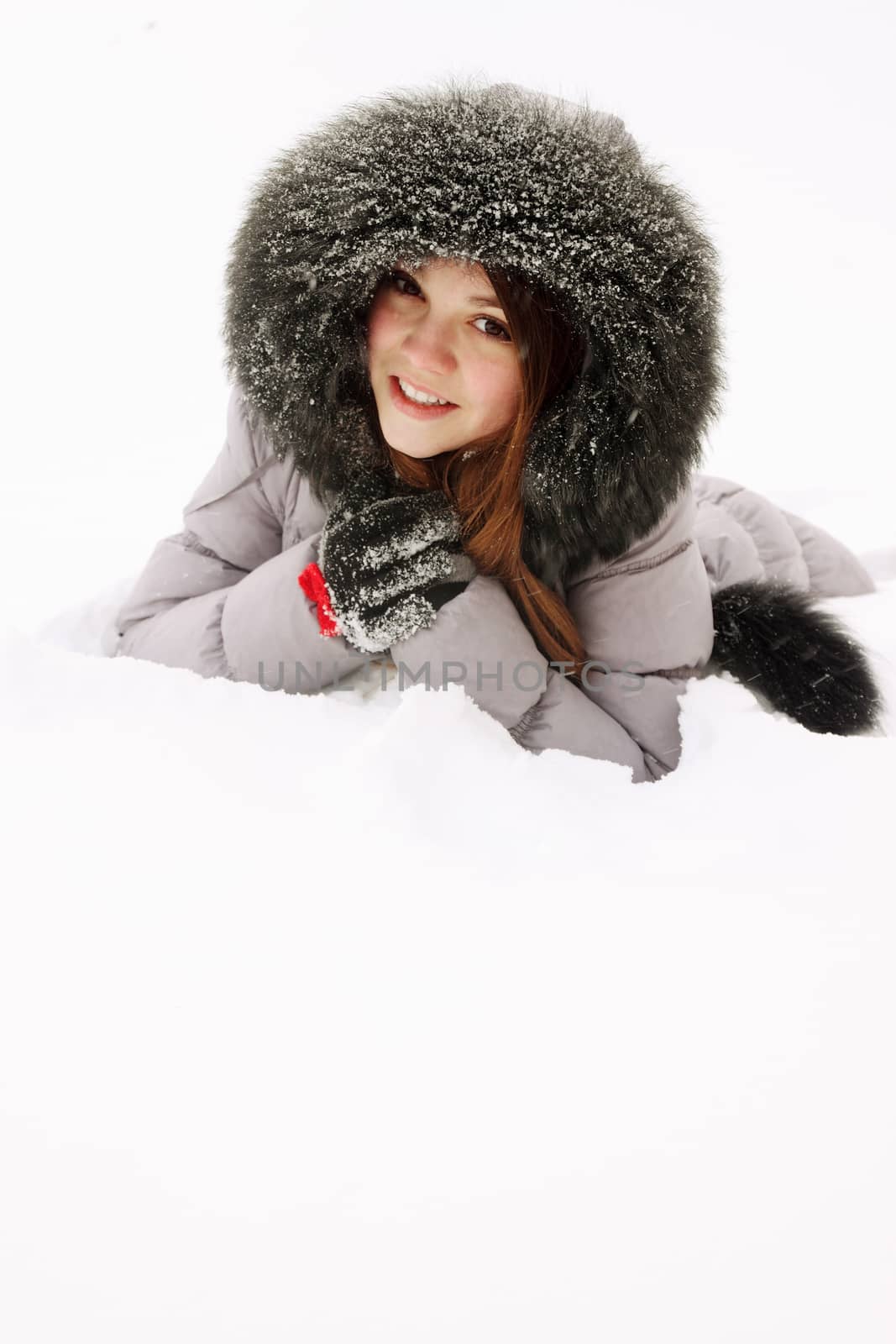 young woman in a fur hood in snow