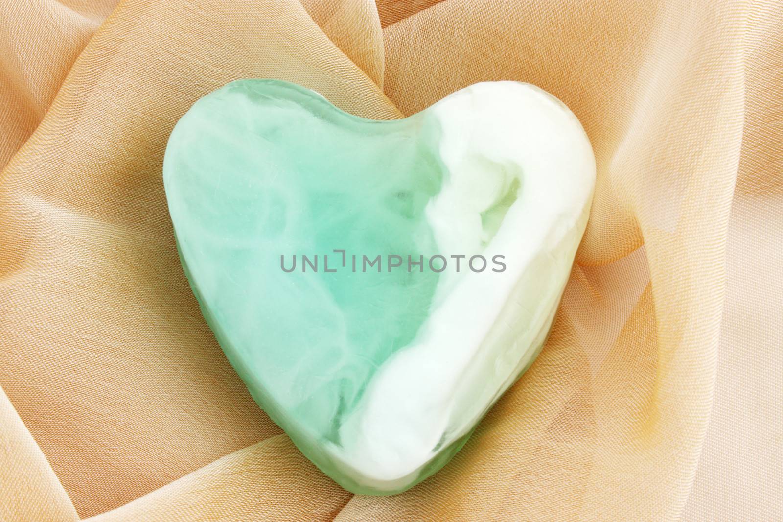 Green  soap in the form of the heart  on the cloth