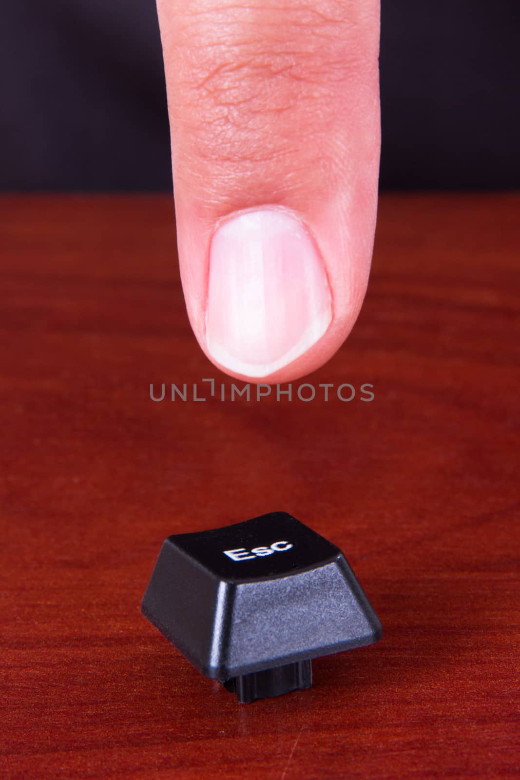 Index finger pointing ESC key.