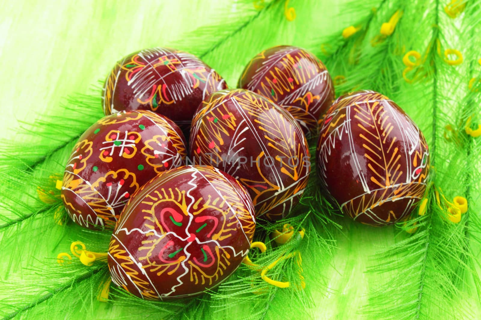 Easter eggs with the manual painting against the green background