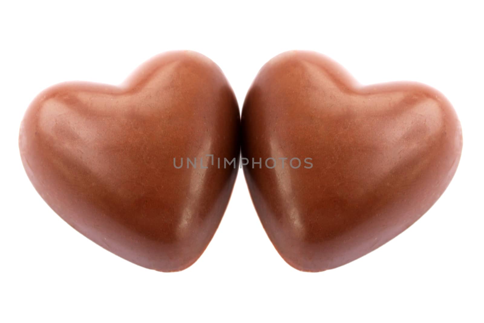 Two chocolate hearts against the white background