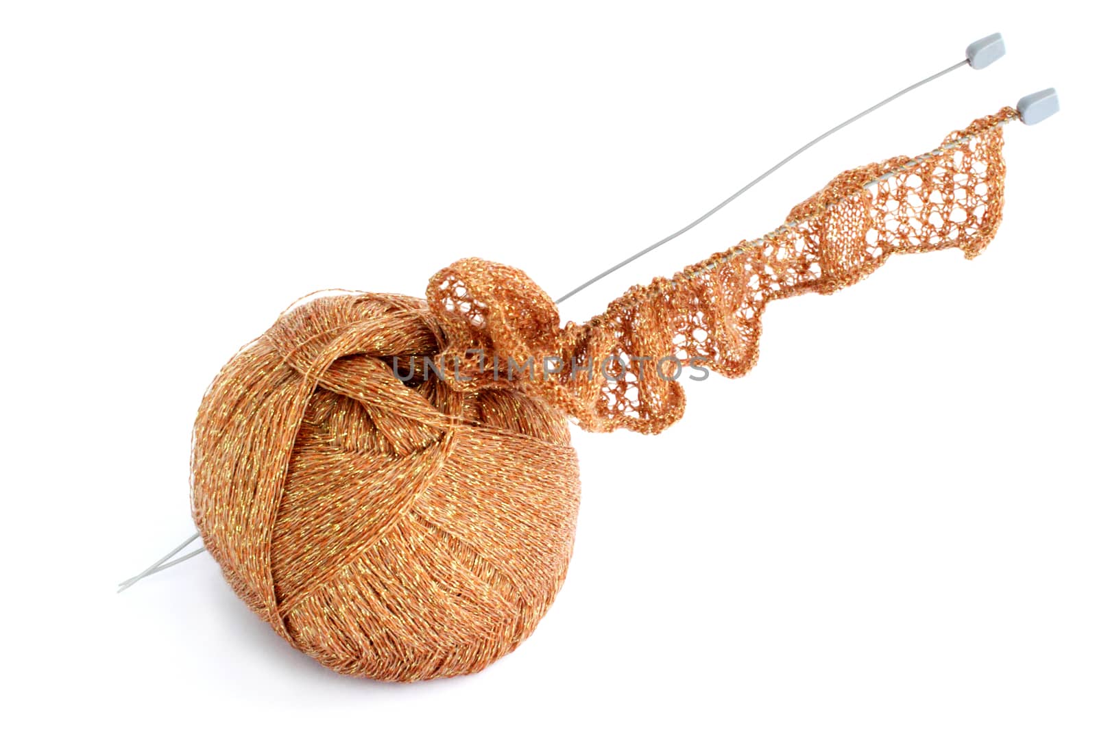 Ball of threads and knitting needle against the white background