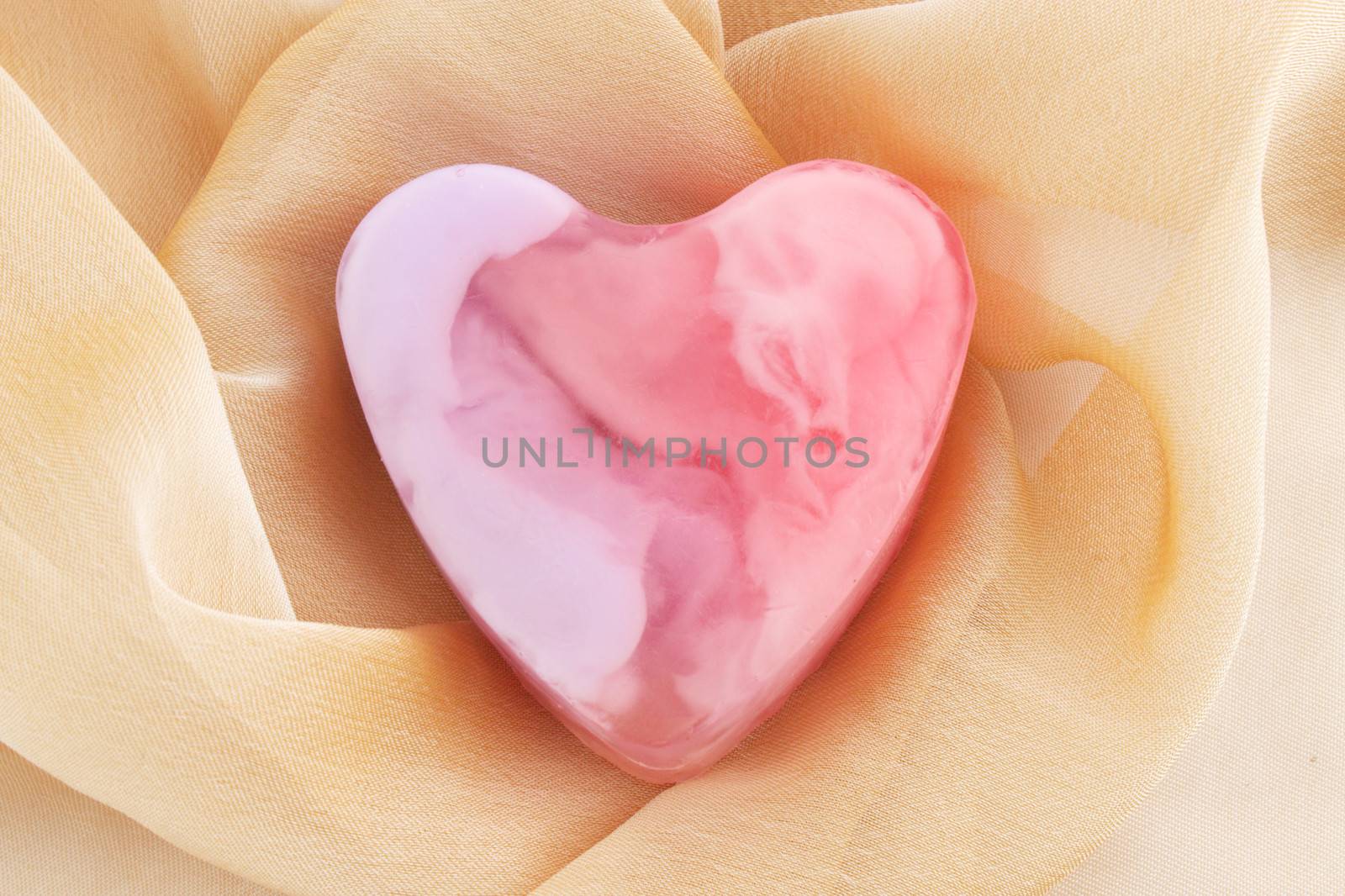 Pink soap in the form of the heart  on the cloth