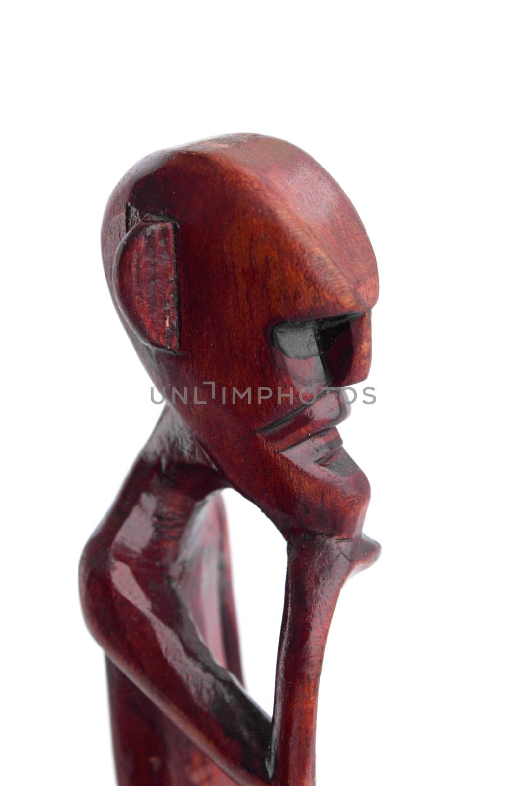 The African statuette of the thinking old man against the white background