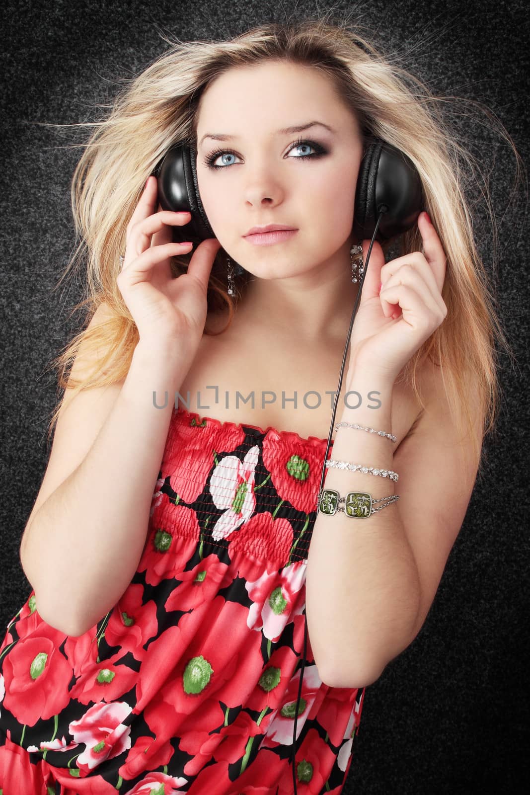 Young beautiful blond listens to the music