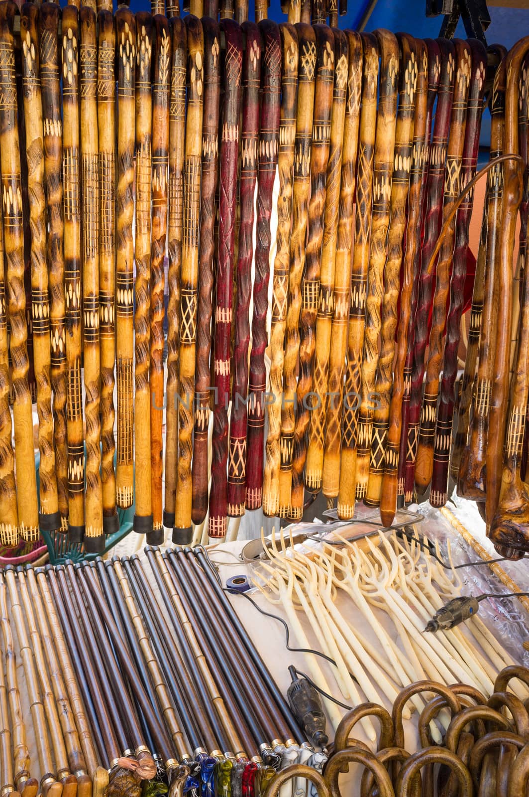 Many walking canes displayed on a  street market stall