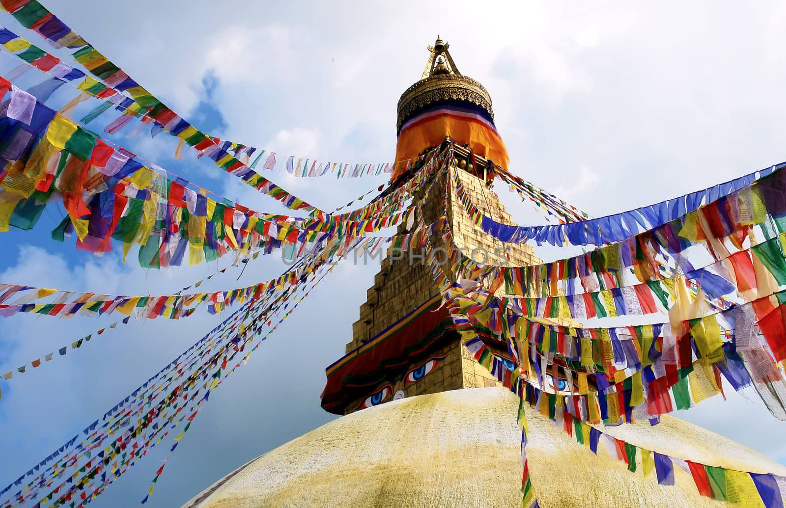 stupa with buddha eyes and prayer flags on clear blue sky backgr by ptxgarfield