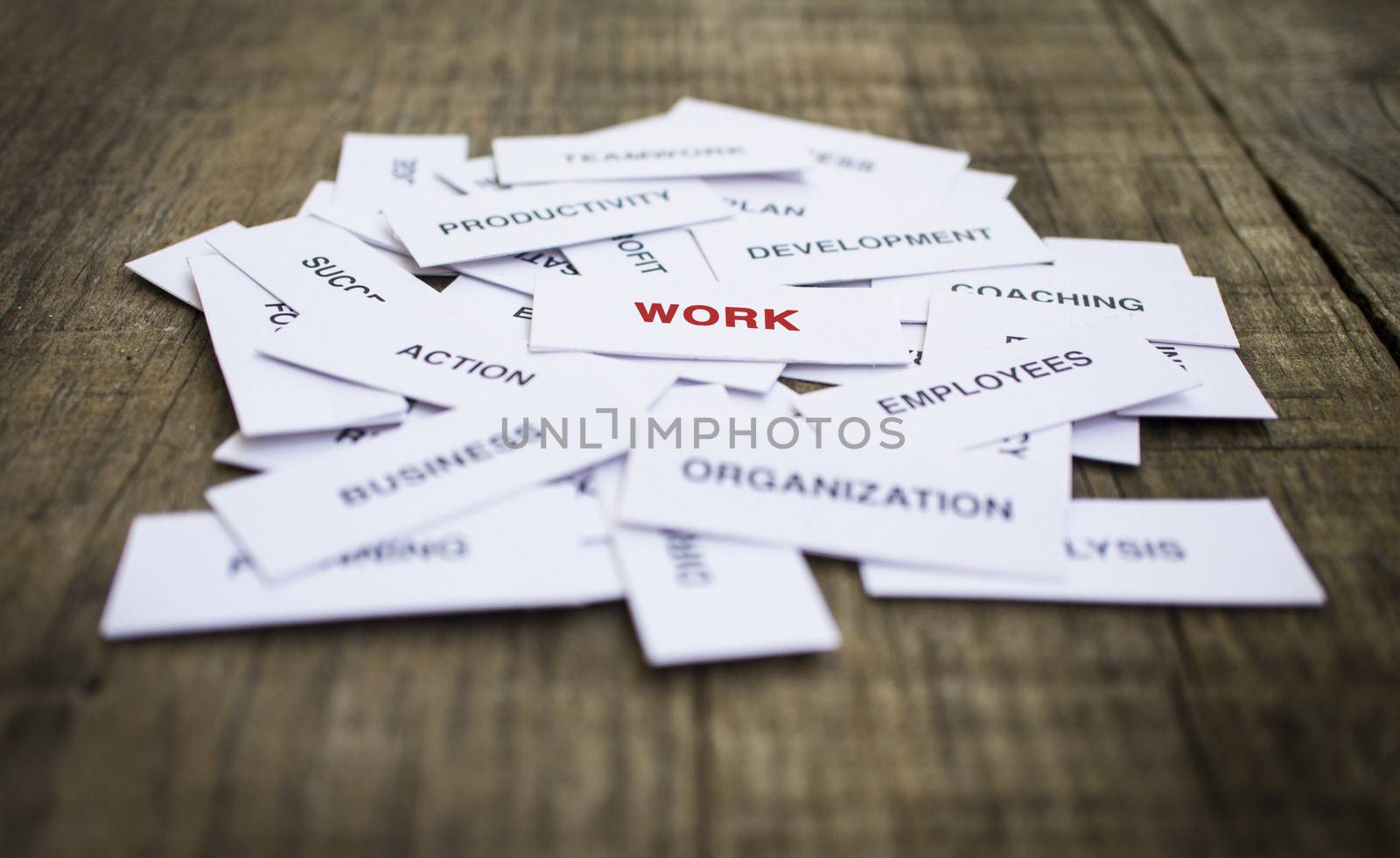 Paper strips with Work related words on wooden background