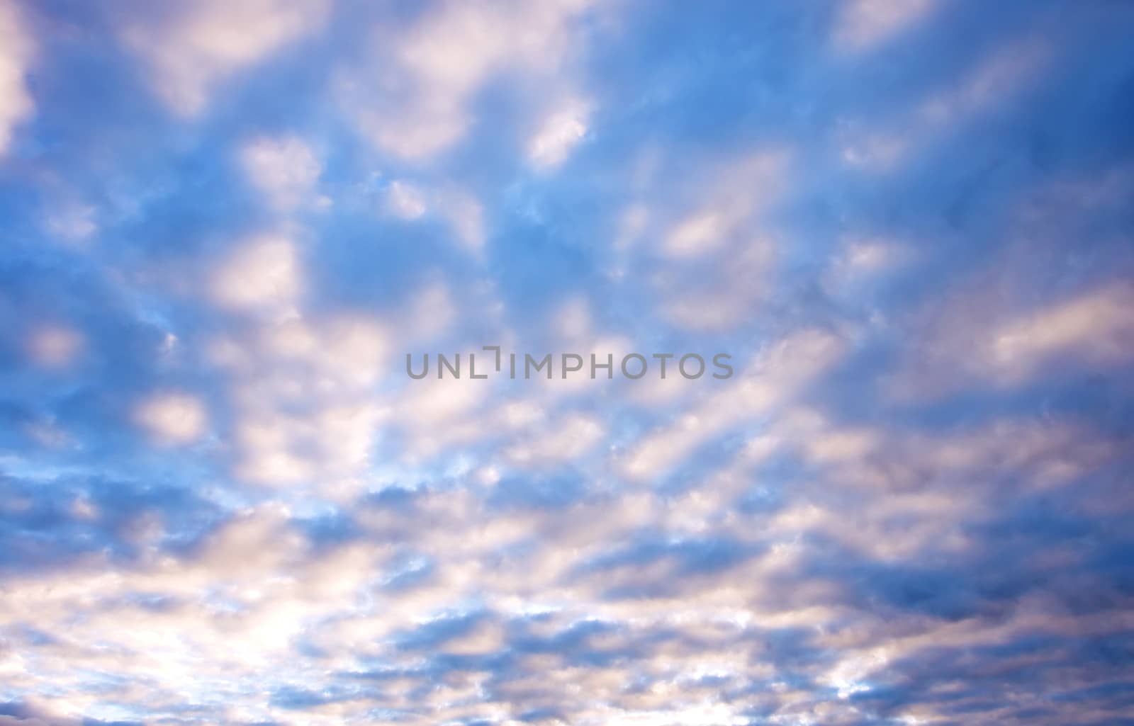 sunlight rays and clouds on the blue sky background