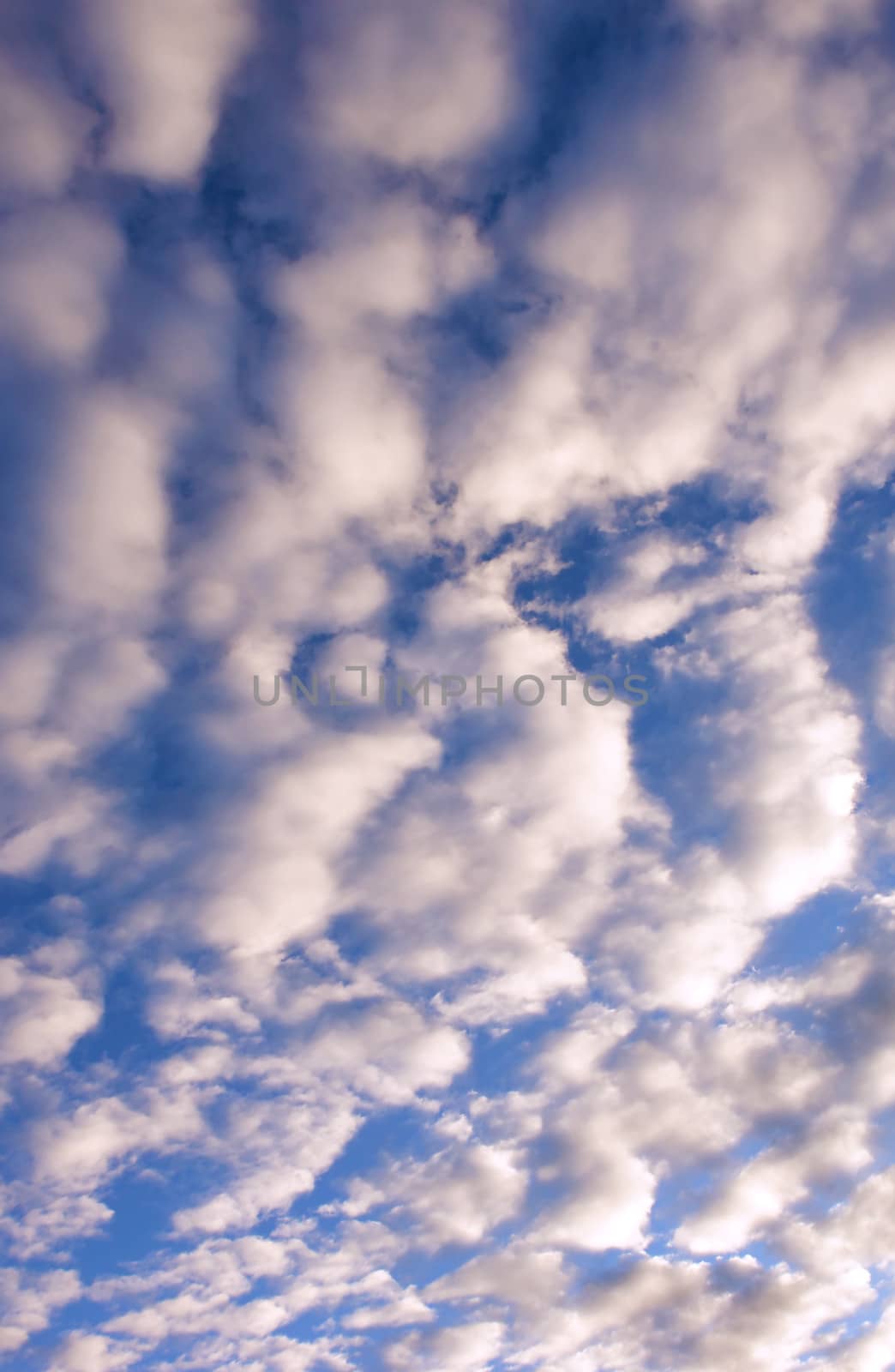 sunlight rays and clouds on the blue sky background
