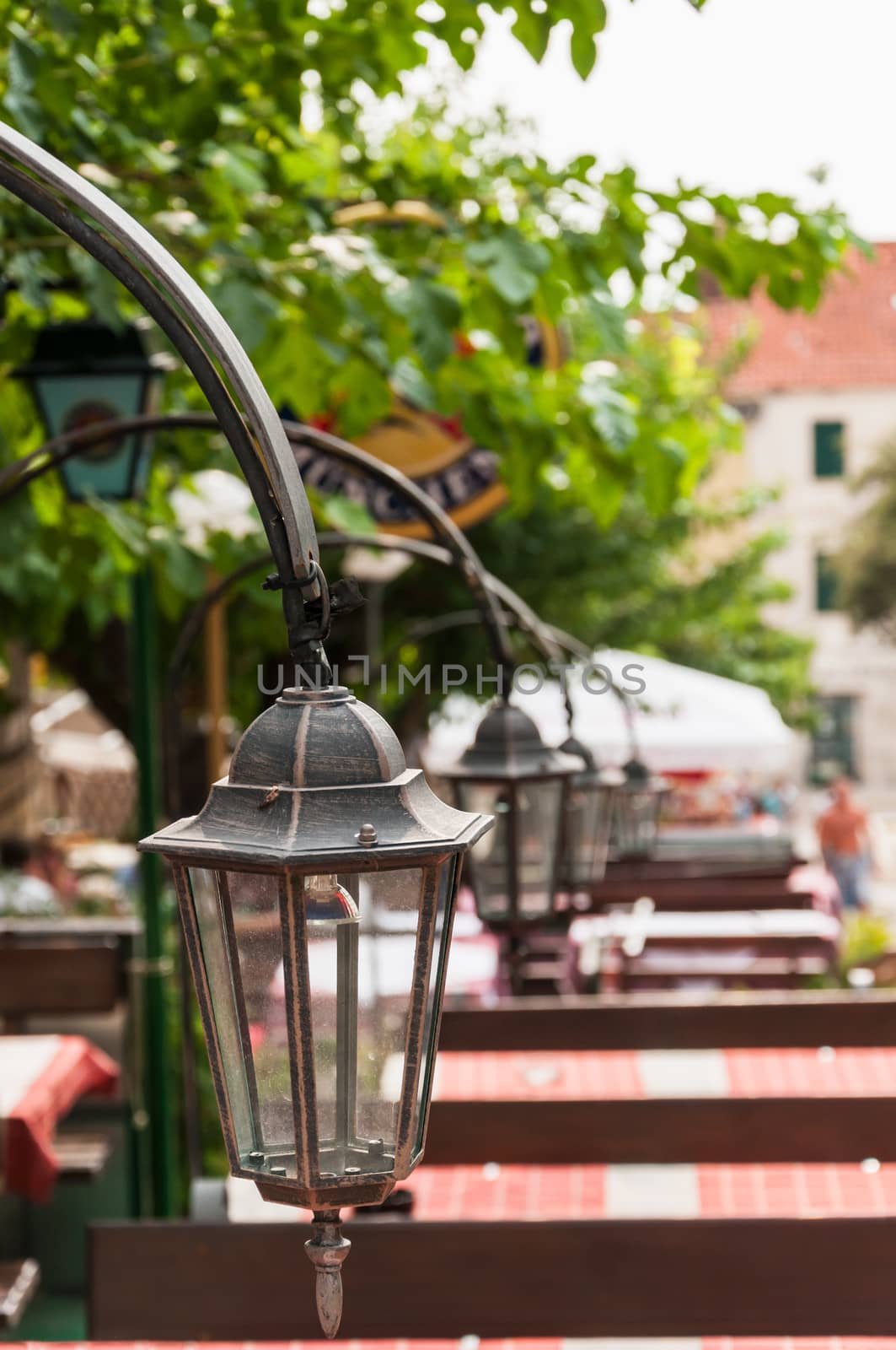 Lanterns in a row on square, Makarska, Croatia.