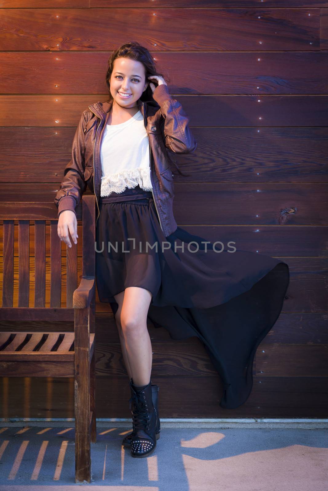 Portrait of a Pretty Mixed Race Young Adult Woman Against a Lustrous Wooden Wall Background.