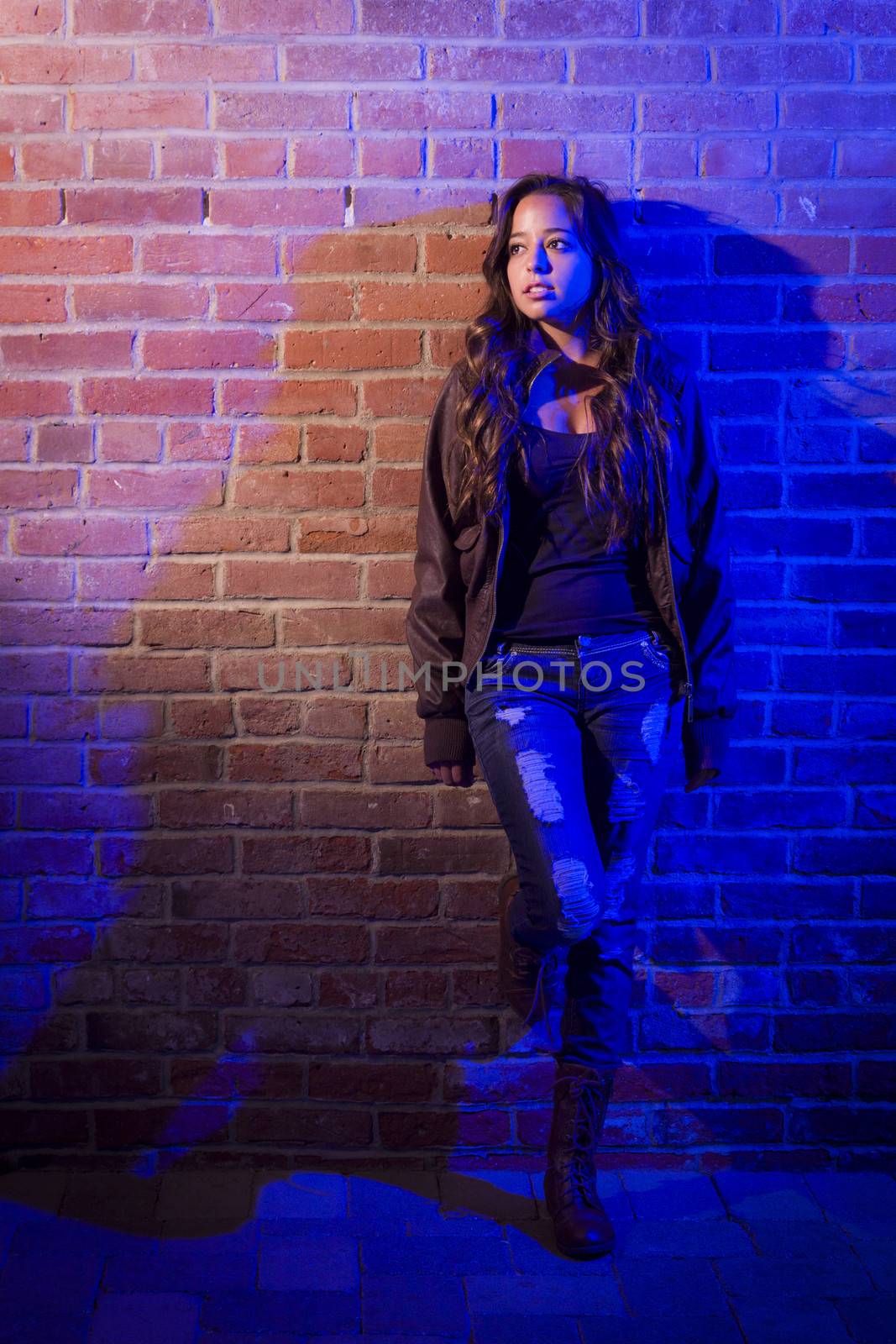 Portrait of a Pretty Mixed Race Young Adult Woman Against a Brick Wall Background.