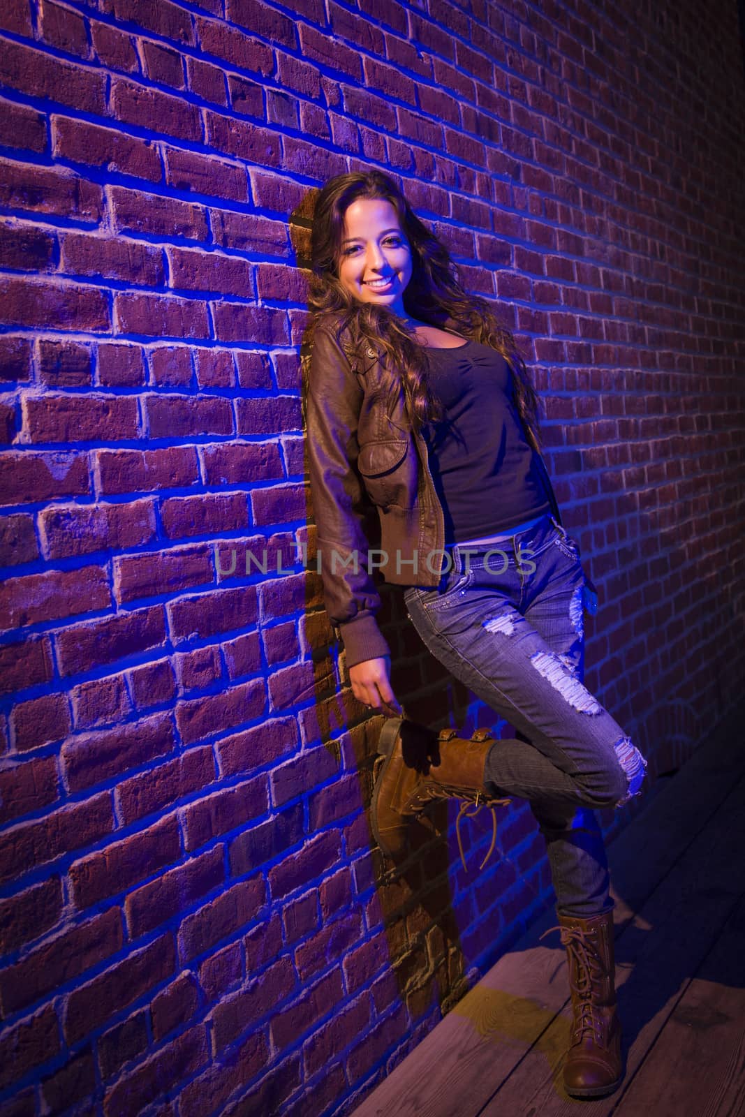 Pretty Mixed Race Young Adult Woman Against a Brick Wall by Feverpitched